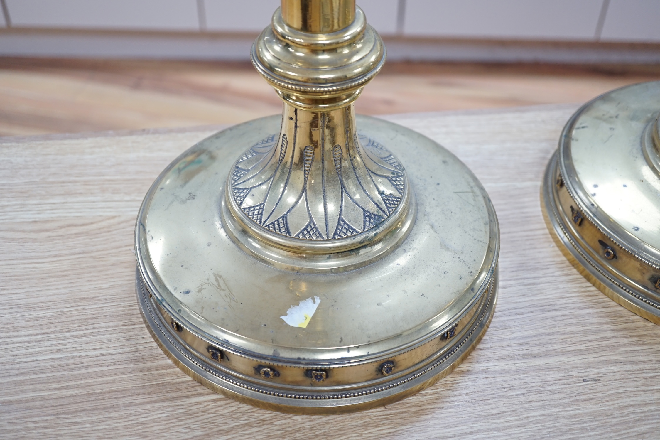 A pair of 19th century tall decorative brass ecclesiastical candlesticks, 90cm high. Condition - fair to good